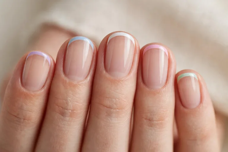 Short oval French tip nails with a natural nude base
