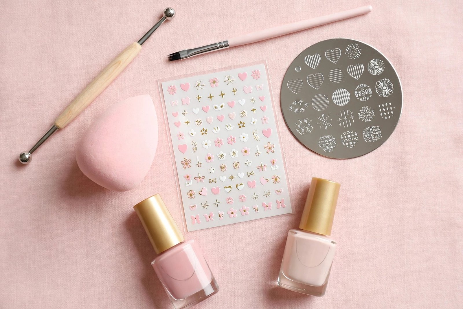 Beginner nail art tools including a dotting tool, detail brush, stamping plate, makeup sponge and nail stickers