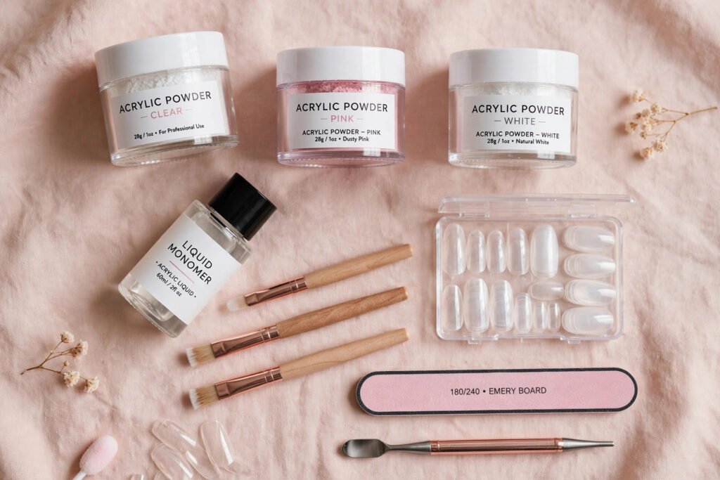 Acrylic nail kit flat lay with powder, monomer and brushes